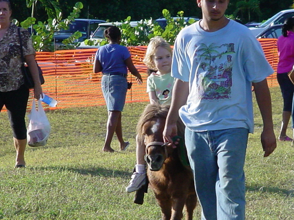 A pony ride.  Miranda is excited :}  The worker is not :{